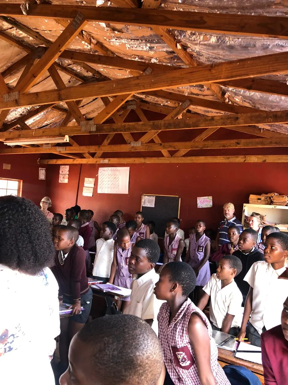 Guests visiting learners in a local school hall