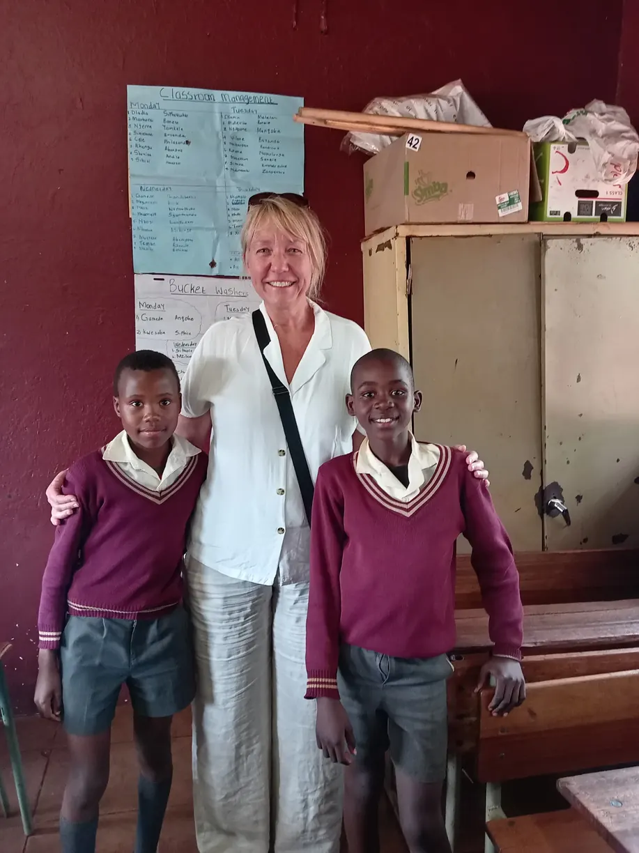 Guest with two learners at a local school