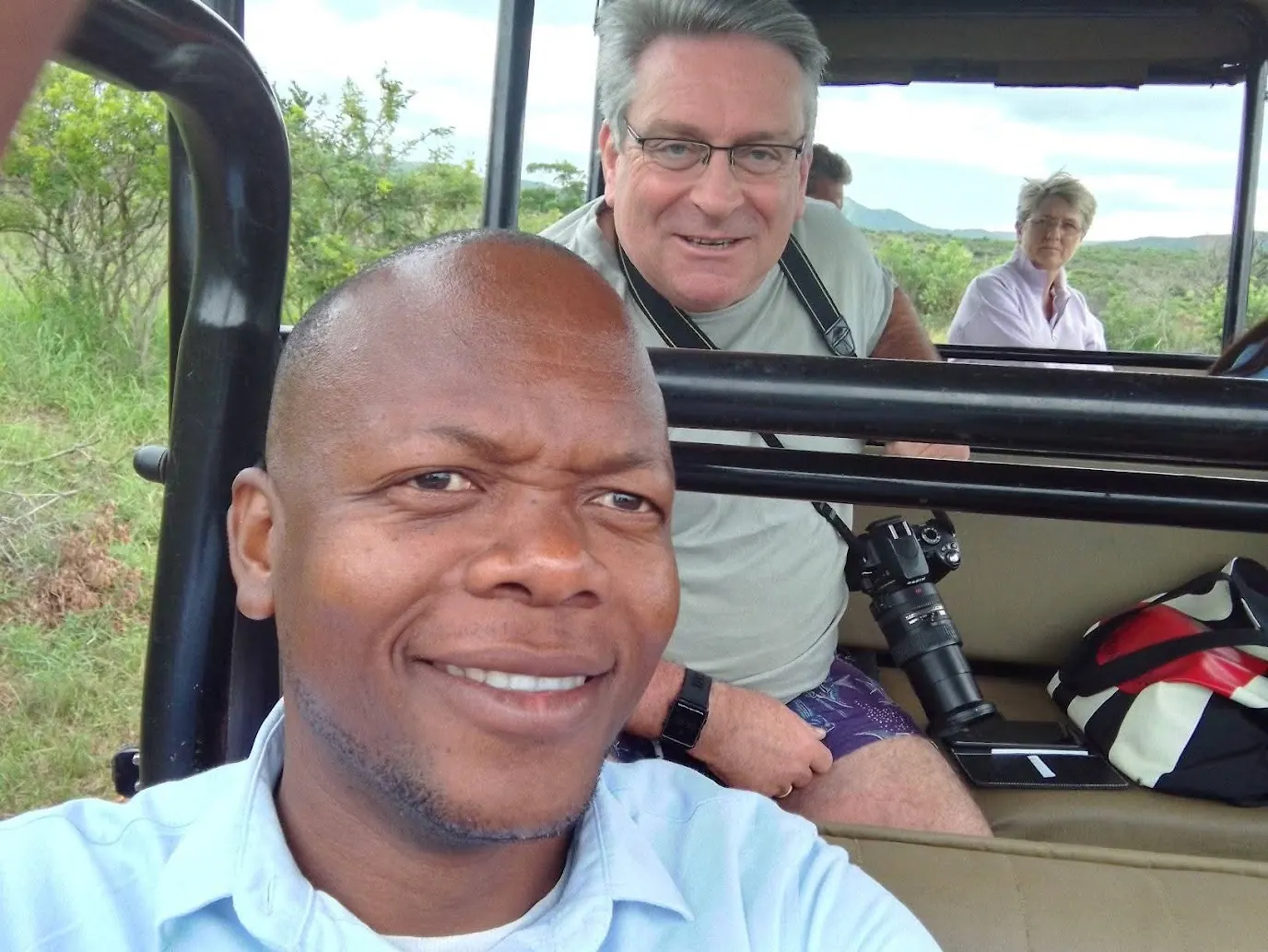 Guide and guests on a game drive vehicle