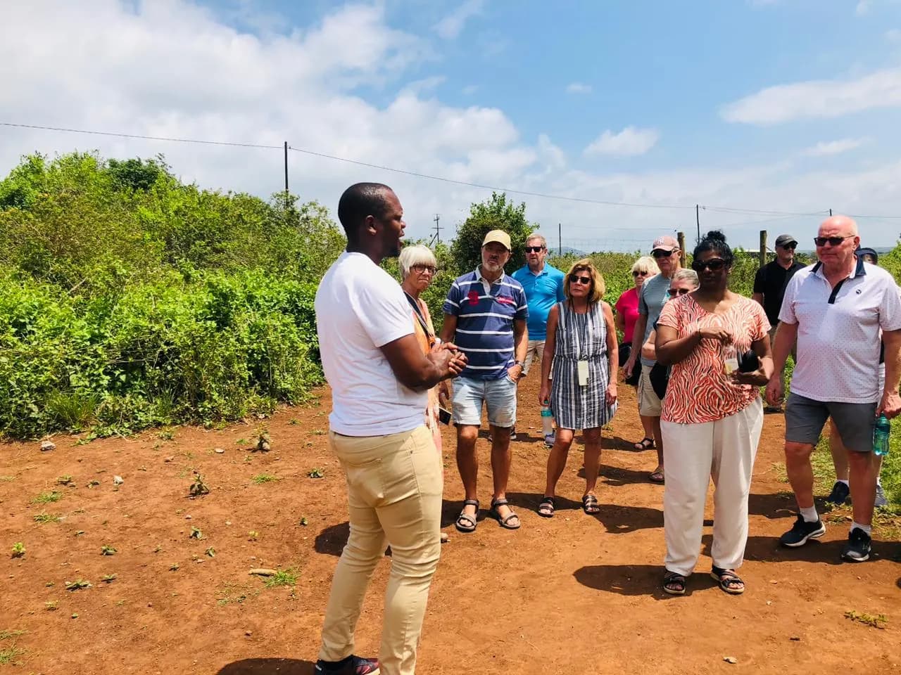 Guests listening to the guide in the village