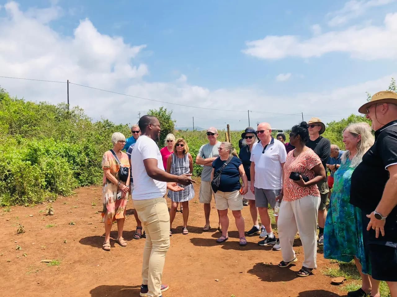 Khondlo Tours guide talking to a tour group outside a homestead