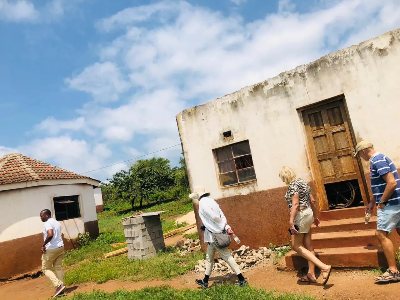 Tour group visiting a village home