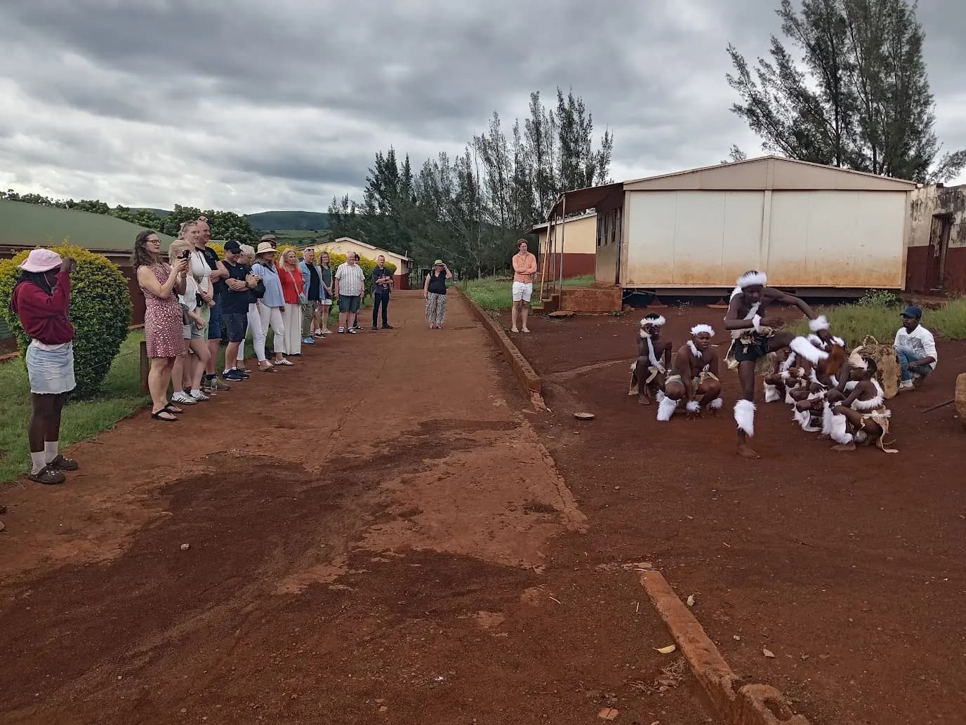 Traditional dancers welcoming guests on a village road