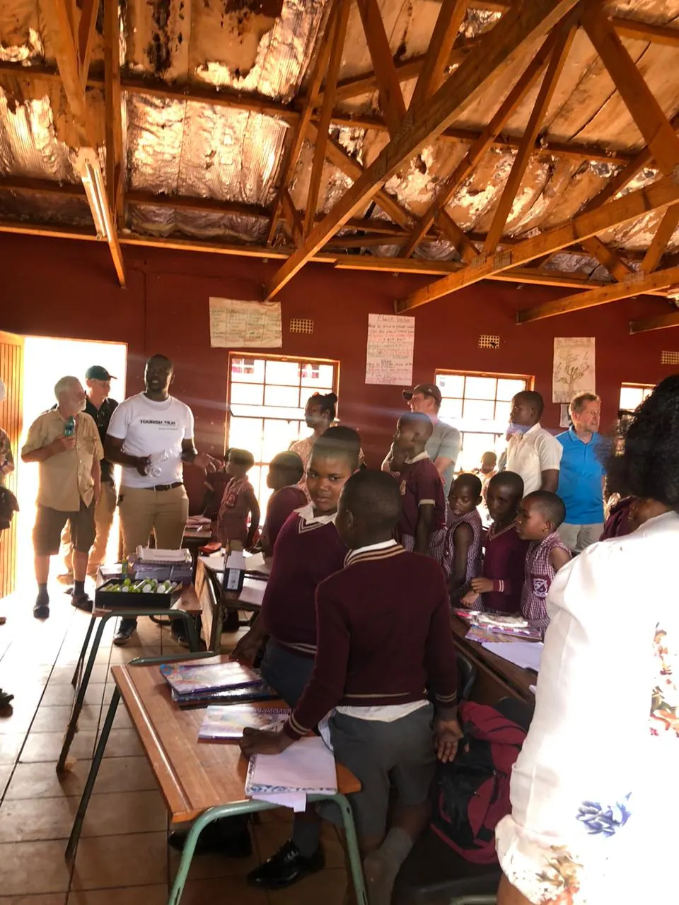 Guests visiting learners in a school hall