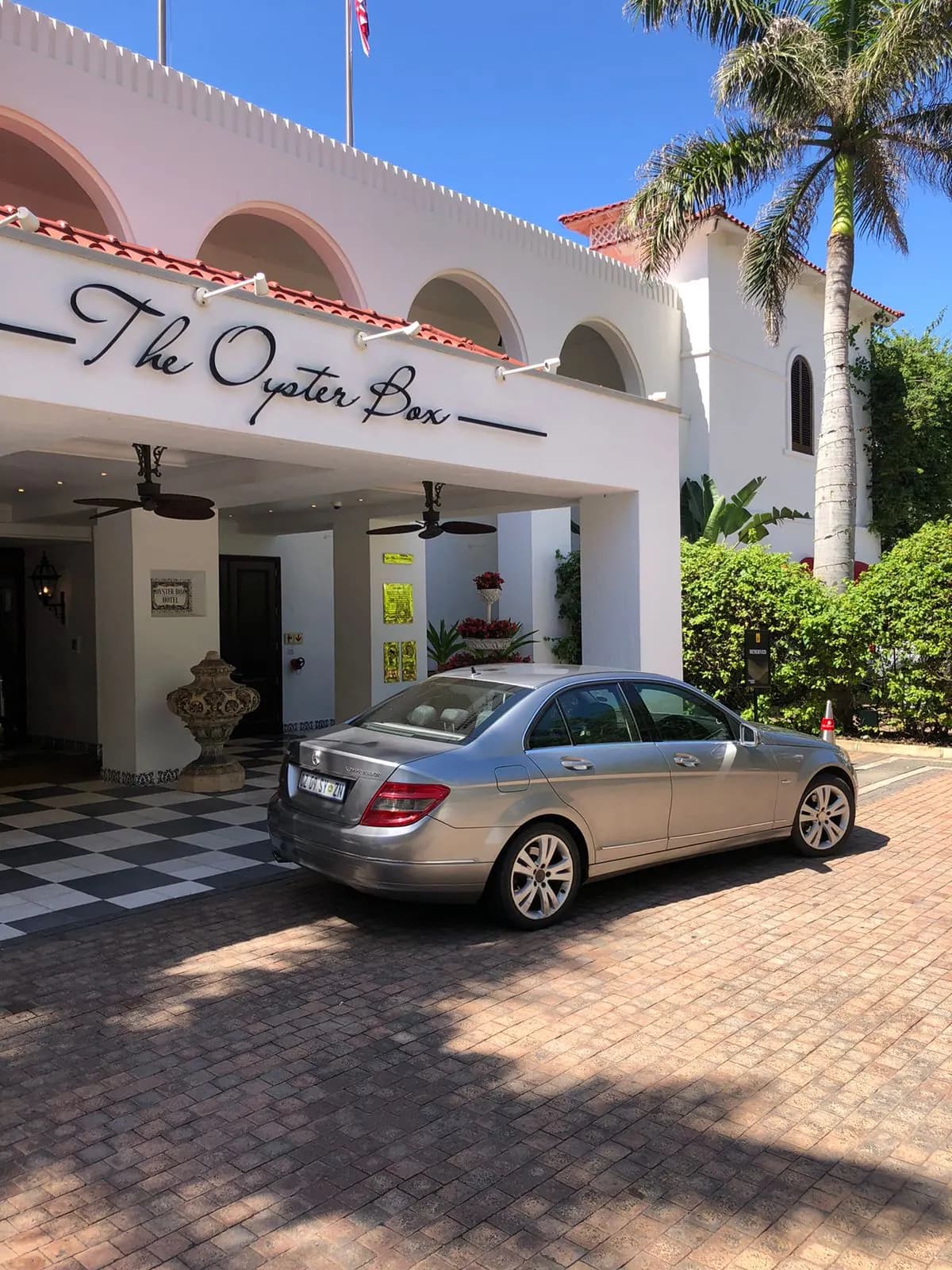 Executive sedan at a coastal hotel entrance